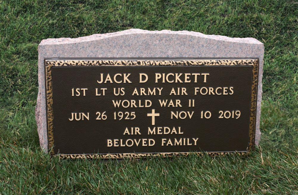 Government bronze marker mounted to back of slant