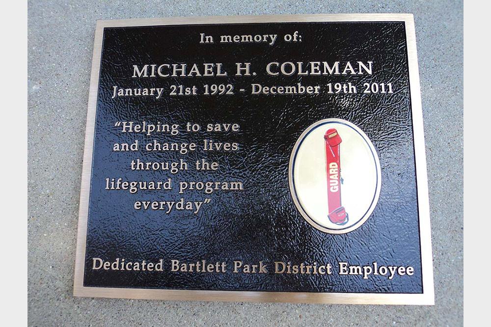 Bronze plaque with color ceramic photo of life guard hat and float